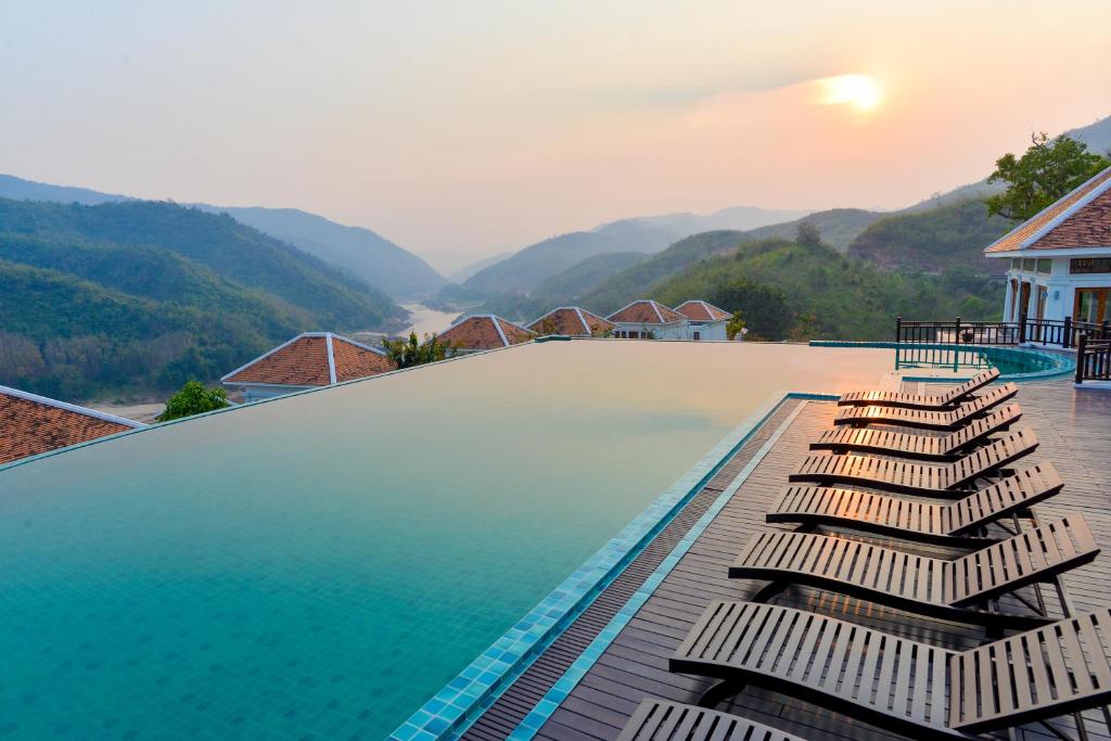 Le Grand Pakbeng Resort, Laos. 5star luxury resort at Pakbeng, along the Mekhong river, between Luang Prabang, Laos and Chiang Rai, Thailand. Set along side the mighty Mekong River and nestled in the undulating lush jungle of northern Laos, the Le Grand Pakbeng is a thriving oasis offering unforgettable experiences with indulgent all-inclusive benefits, featuring gourmet dining and enriching daily activities. This charming resort provides 45 nicely appointed villas and suites with private terraces and Jacuzzi, which are furnished using local artworks in a mix of the splendid scenery of the Mekong River and the surrounding mountainside. Pakbeng is a beautiful riverside village on the banks of the Mekong River, halfway between Houay Xay and Luang Prabang, a wonderful place to observe the laid-back sleepy village life. Take it easy, enjoy the atmosphere and stunning scenery while sipping cocktails at Le Grand Pakbeng's poolside bar and getting pampered in the Le Bristro Lounge. To those who travel by cruise on the mighty Mekong River. Staying just only one night is not worth it as your boat arrives in the late afternoon and depart for boat jetty in early morning. You won't have enough chance to relax and enjoy our full facilities and excursion visiting the unique culture heritage of local hilltribe villages. 5star luxury resort at Pakbeng, along the Mekhong river, between Luang Prabang, Laos and Chiang Rai, Thailand. Set along side the mighty Mekong River and nestled in the undulating lush jungle of northern Laos, the Le Grand Pakbeng is a thriving oasis offering unforgettable experiences with indulgent all-inclusive benefits, featuring gourmet dining and enriching daily activities. This charming resort provides 45 nicely appointed villas and suites with private terraces and Jacuzzi, which are furnished using local artworks in a mix of the splendid scenery of the Mekong River and the surrounding mountainside. Pakbeng is a beautiful riverside village on the banks of the Mekong River, halfway between Houay Xay and Luang Prabang, a wonderful place to observe the laid-back sleepy village life. Take it easy, enjoy the atmosphere and stunning scenery while sipping cocktails at Le Grand Pakbeng's poolside bar and getting pampered in the Le Bristro Lounge. To those who travel by cruise on the mighty Mekong River. Staying just only one night is not worth it as your boat arrives in the late afternoon and depart for boat jetty in early morning. You won't have enough chance to relax and enjoy our full facilities and excursion visiting the unique culture heritage of local hilltribe villages.