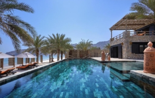 Nestled in Oman’s dramatic Musandam Peninsula, where rugged mountains dive into vibrant emerald waters, across a powdery sand beach, the village-inspired resort in Oman. It offers a range of villas, suites, and beachfront retreats, each with a private pool, traditional summer house and the time and space to find yourself.
